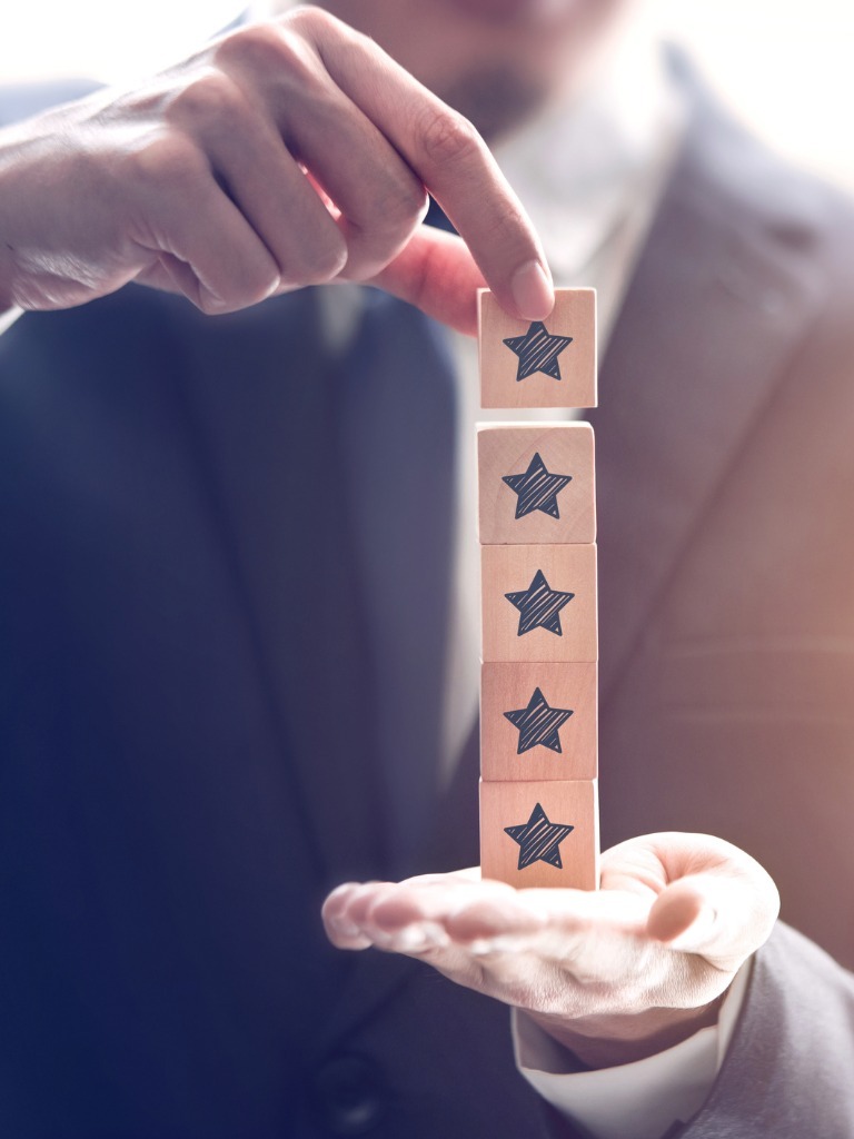businessman-holding-five-star-symbol